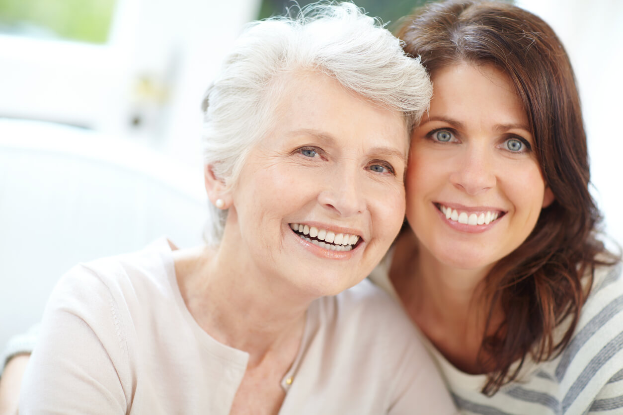 Mother and daughter smiling together, prioritizing health across generations